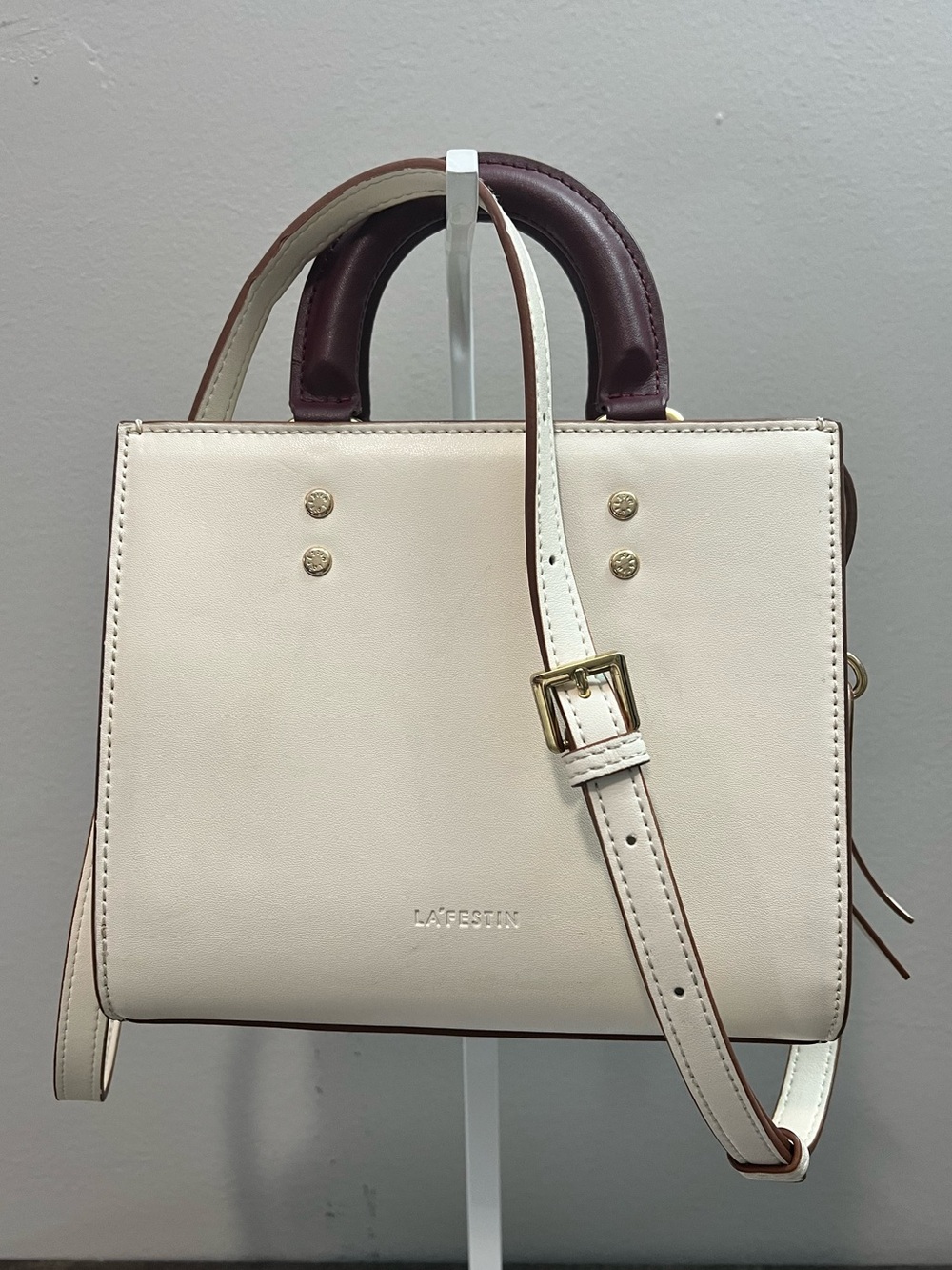 Cream Leather with contrasting plum handles and goldtone hardware crossbody.